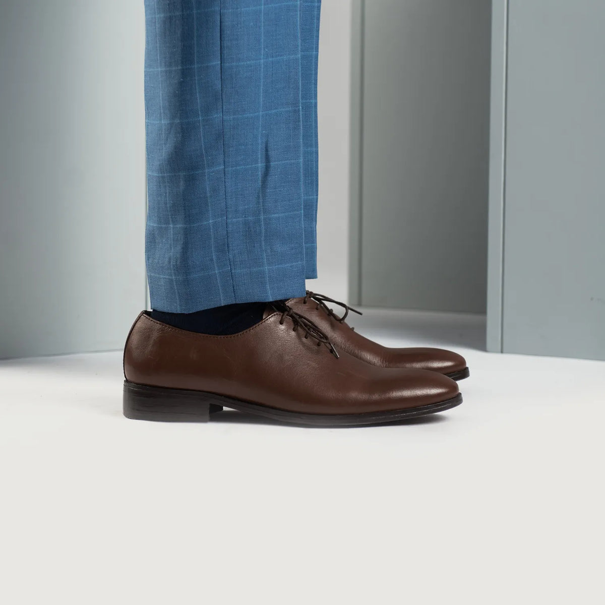 Styled Fit Perspective of Director Wholecut Brown Leather Shoes For Men on Model - Natural Daylight Drape